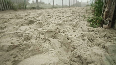 sandy path with footprints in sand on dewey beach, delaware, slow motion