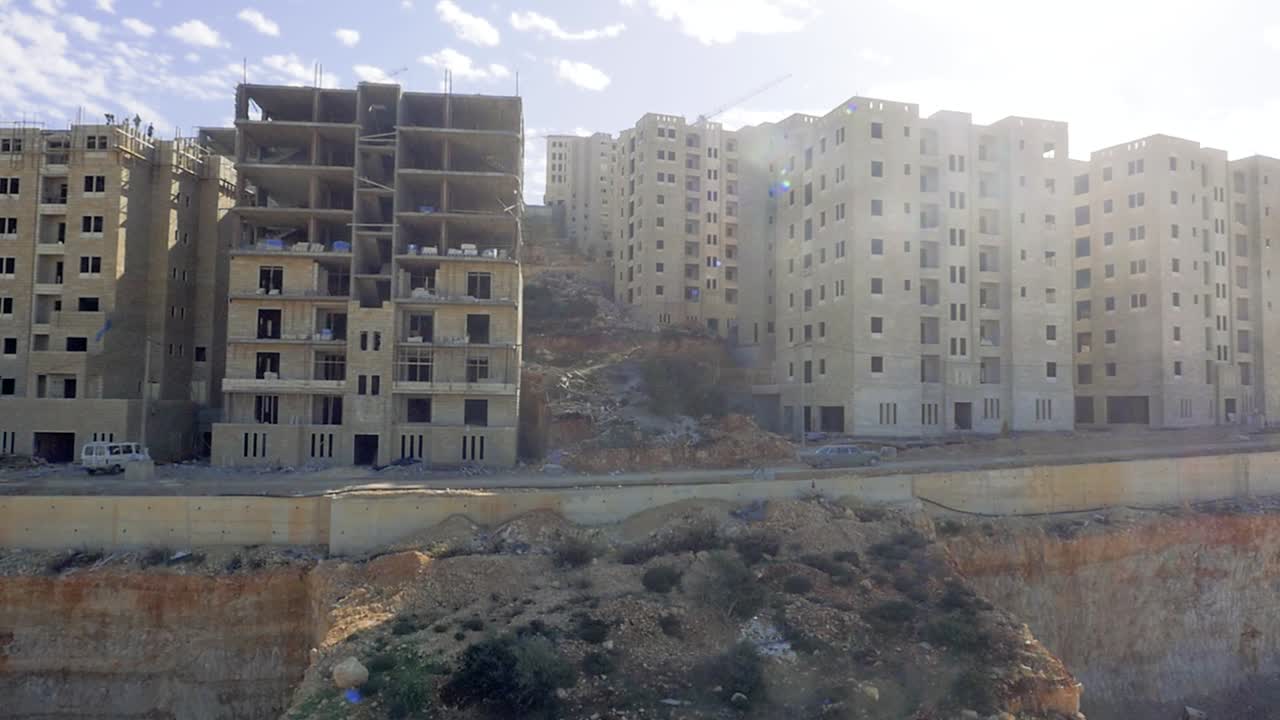 Aerial, incomplete forgotten highrise buildings in middle eastern city