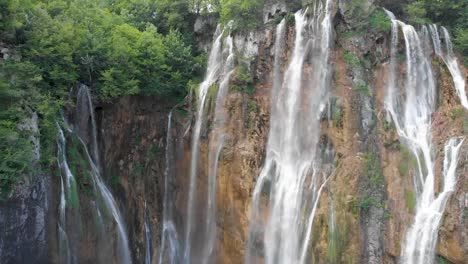 close up ascending aerial shot of a tall waterfall