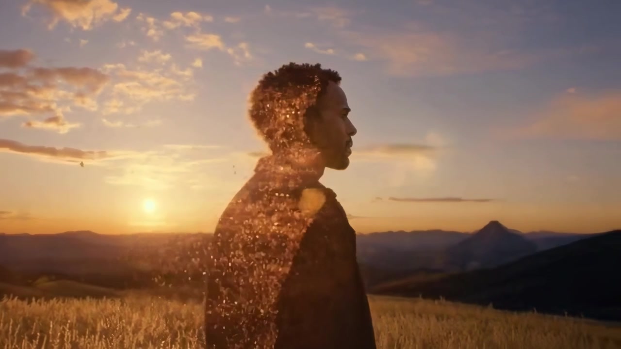 Man Standing in Golden Field at Sunset with Particle Effect