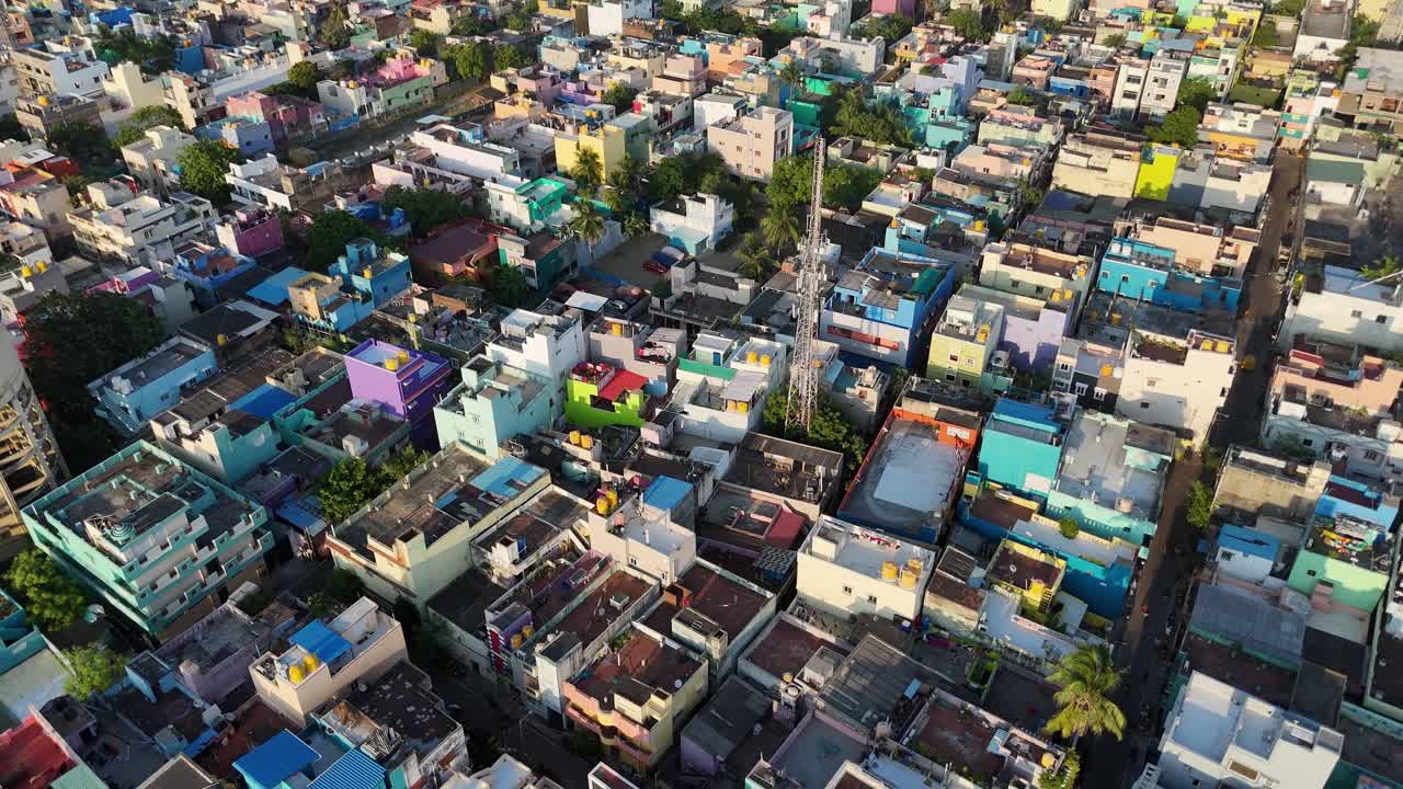 Aerial footage of temple gopurams rising amidst densely packed buildings