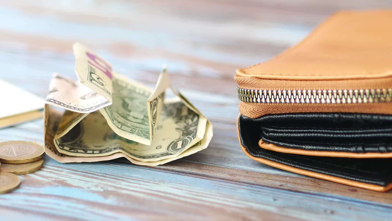 Money and wallet on a wooden table