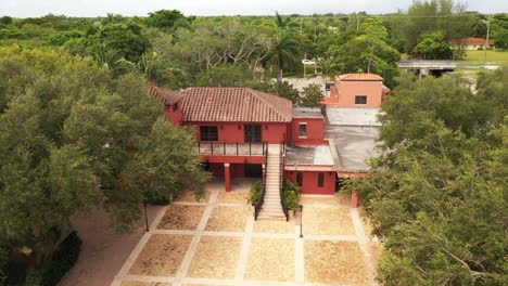 slow descent revealing spanish styled house in public park