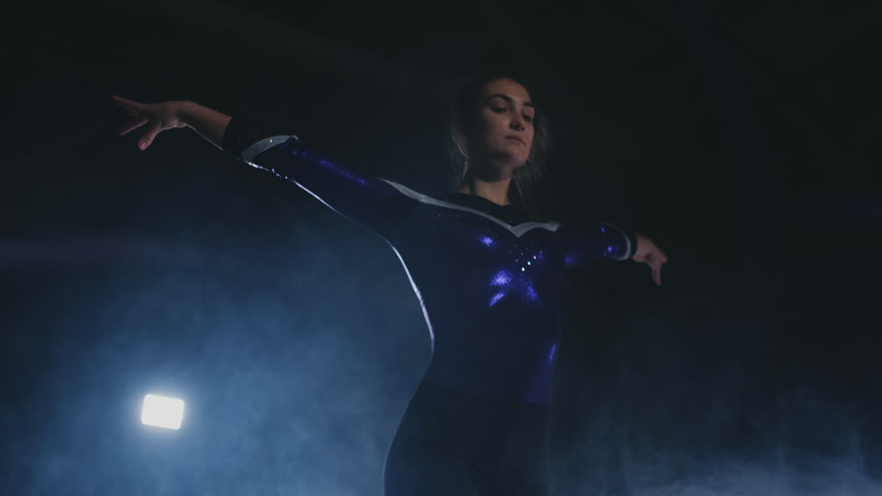 Balance beam close-up girl's legs land after the jump.