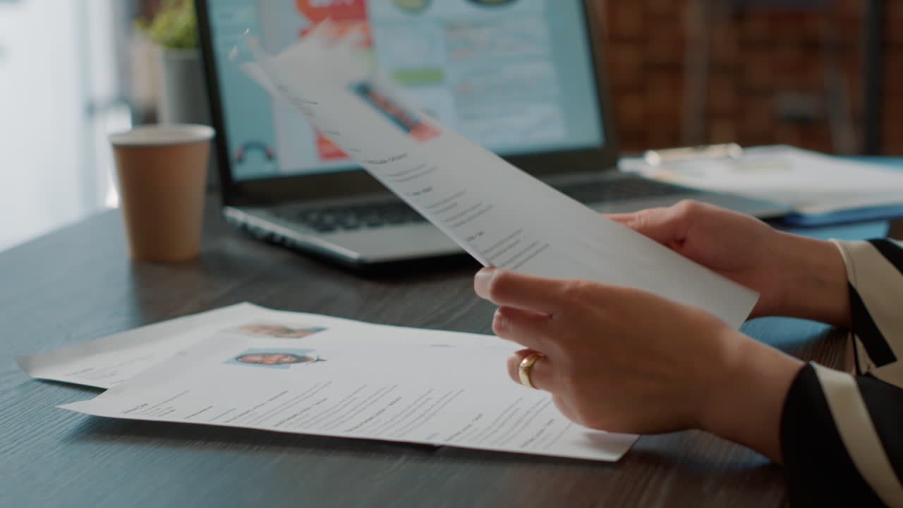 HR recruiter analyzing cv files of candidates in company office