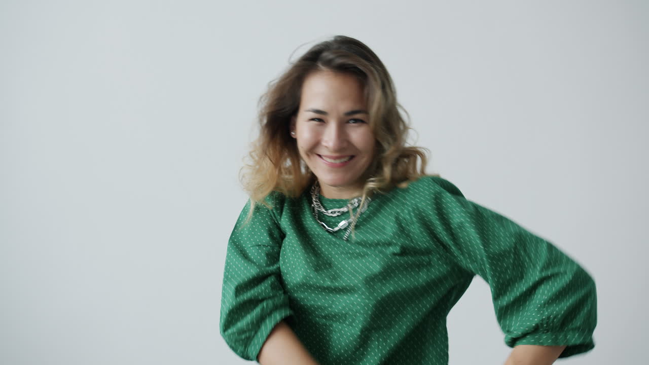 Woman Dancing in a Green Polka Dot Shirt