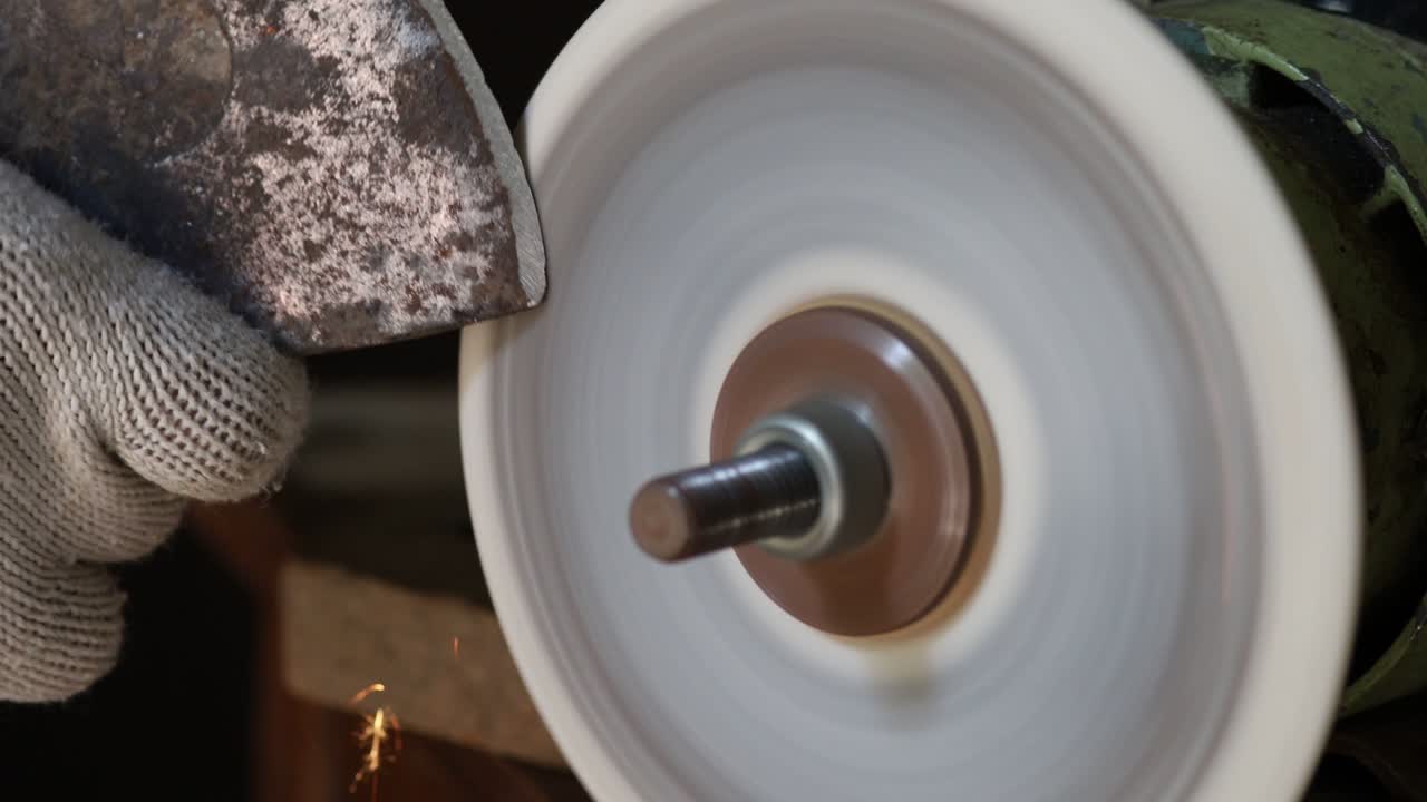 Sharpening an ax on a sharpener
