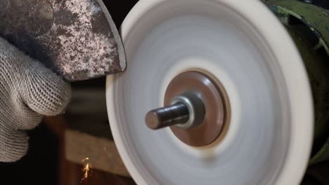 sharpening an ax on a sharpener