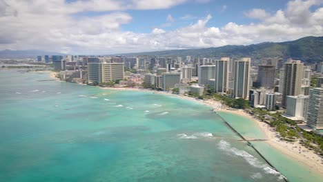 kuhio beach park and waikiki skyscrapers on the coast of honolulu, hawaii