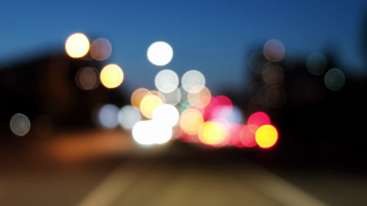 Blurred view of cars moving on the streets of the city in the evening