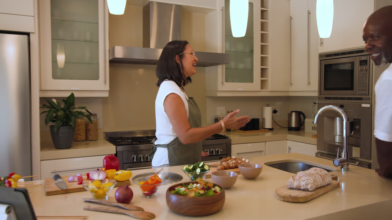 Cooking together in modern kitchen, diverse friends sharing conversation and laughter, at home