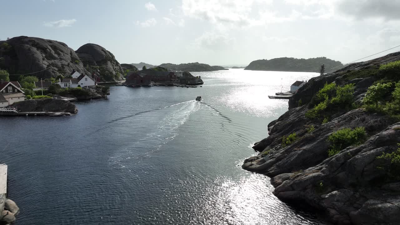 Golden hour shot of Kapelløya, with the sea shimmering between the islands