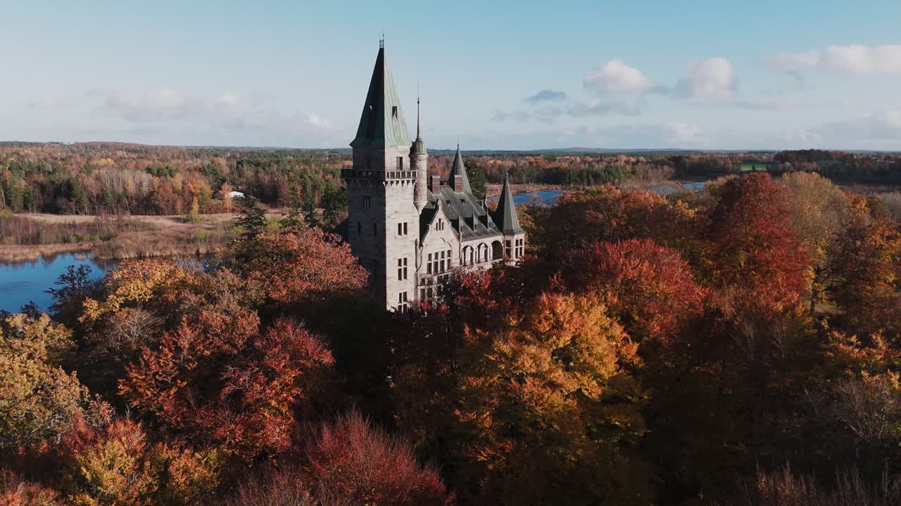 Tracking shot towards Teleborg Castle in Växjo, Sweden, Fall, Orange and Yellow Leafs, Sunset