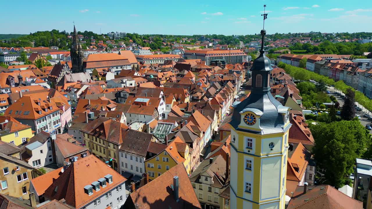 4K Aerial Drone Video of the Historic Herrieder Clock Tower and the St. Johannis Church in the Old Town area of Downtown Ansbach, Germany