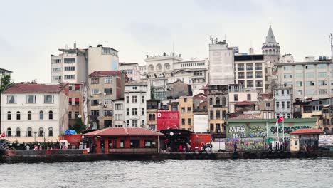 view of istanbul cityscape galata tower with floating tourist boats in bosphorus ,istanbul turkey