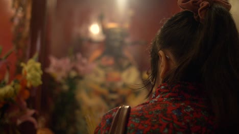 lady praying in man mo temple