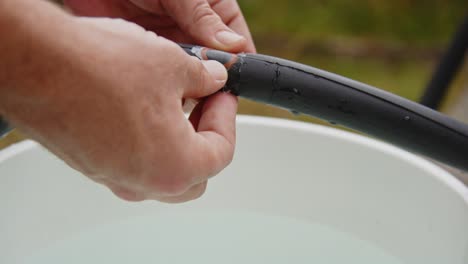 hand firmly placing rubber repair patch on punctured bicycle tire