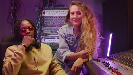 portrait of multiethnic man and woman in recording studio