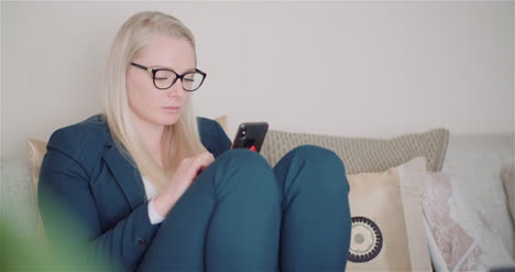 businesswoman using mobile phone on sofa 9