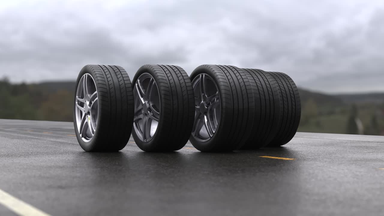 Loop four car wheels rolling on wet asphalt against the background of mountains