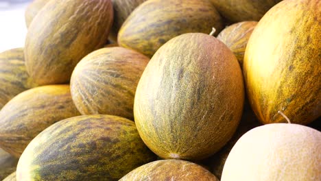 close up of a pile of cantaloupes