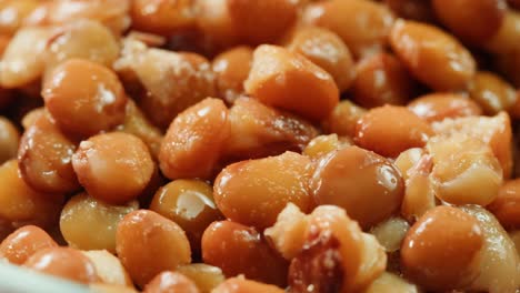 lentils macro, open metal can with preserved steamed brown lentils close up isolated on white background