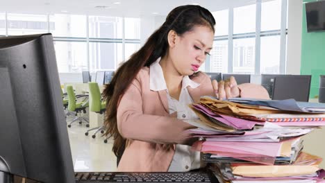 business woman finding document in office room