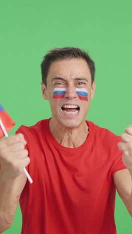 Man cheering for Russia screaming and waving a national flag