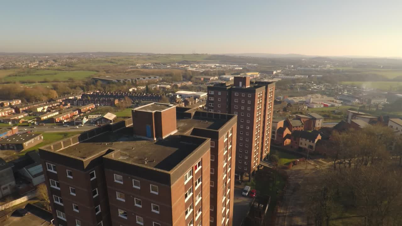 Aerial footage view of high rise tower blocks, flats built in the city of Stoke on Trent to accommodate the increasing population, council housing crisis, Immigration housing