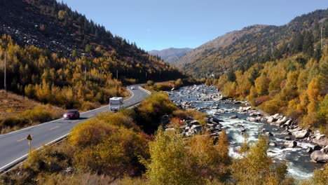 Campervan-drives-along-scenic-autumn-highway-by-river-in-Xingdu-Qiao-Jia-Genba-Tibetan-Sichuan-Western-China