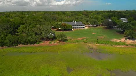 Aerial-drone-footage-of-a-waterfront-building-and-park-area