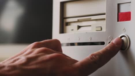 hand turning on vintage computer