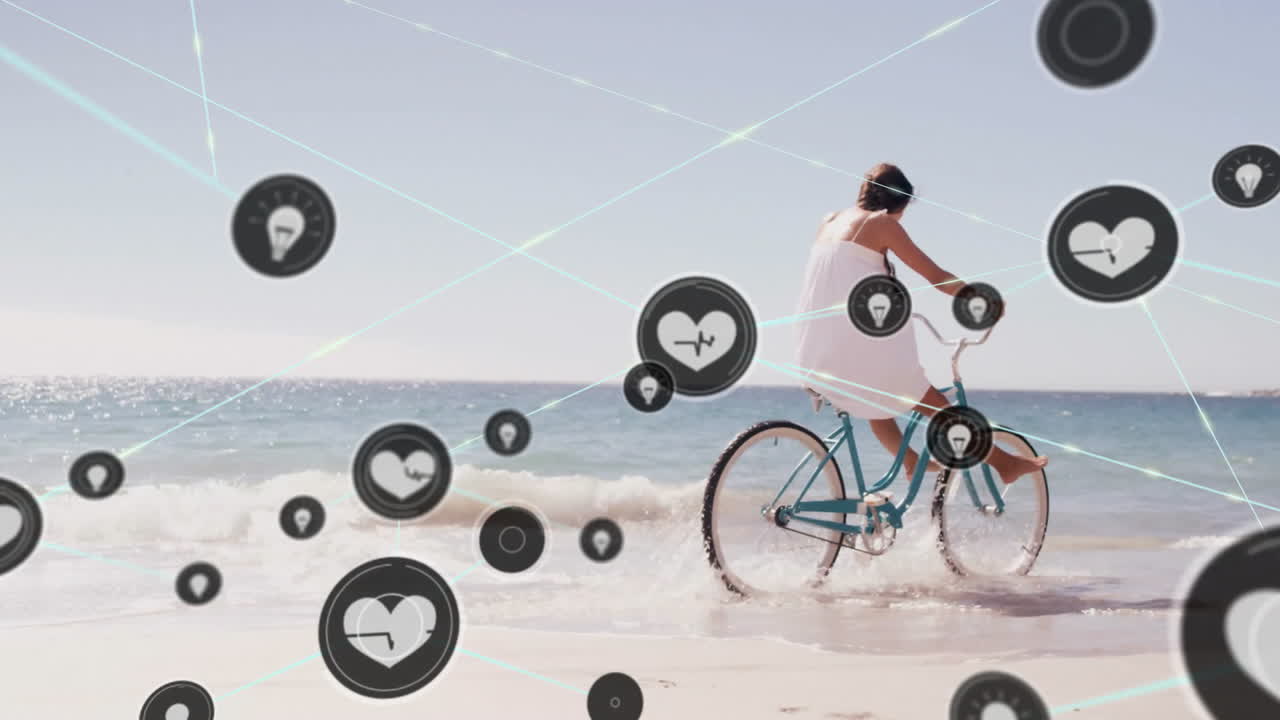 Animation of networks of connections with heart icons over caucasian woman cycling on beach