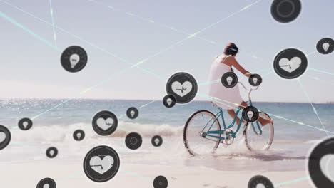 animation of networks of connections with heart icons over caucasian woman cycling on beach