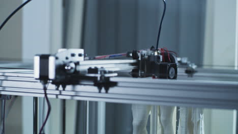 close-up of a 3d printer's mechanical components in operation