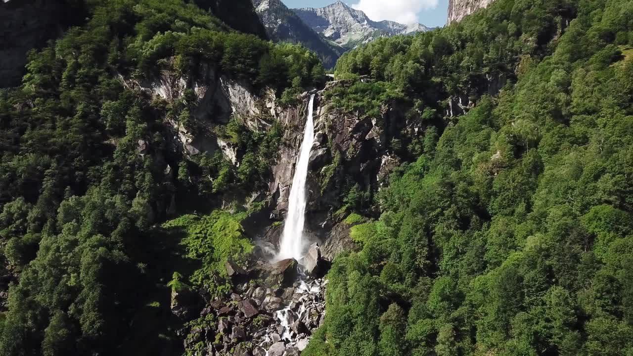 Breathtaking aerial view of a stunning waterfall cascading down a rocky cliff face, surrounded by a vibrant green forest, Foroglio waterfalls, Bavona Vallet, Ticino Canton , Switzerland