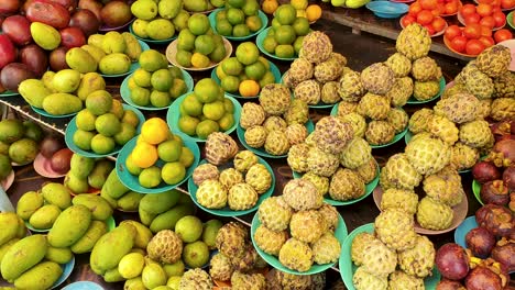 market stall of colourful exotic tropical fruits displayed on plates in capital city dili, timor-leste, southeast asia