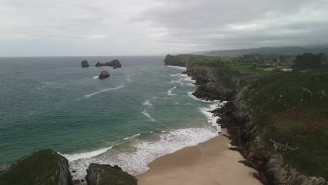 Aerial-view-of-cliff-with-beach-and-ocean-in-Northern-Spain