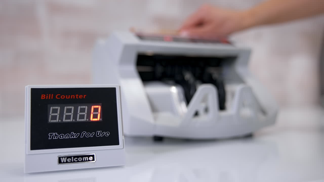 Automated cash money counting machine. Banknote counter are counting fifty euro bills. Electronic money counter with euro banknotes.