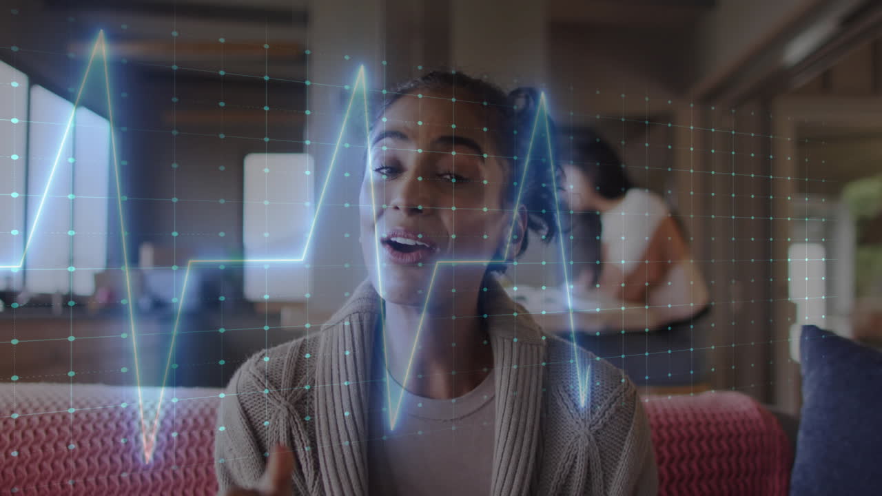 Woman talking with digital heartbeat animation overlay in cozy living room