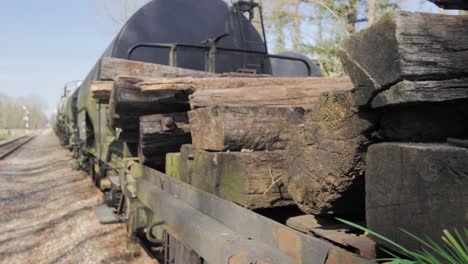 old train car loaded with wooden logs