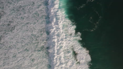 grandes olas chocan creando una textura de espuma blanca