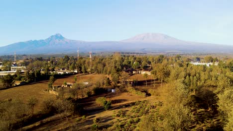 sunrise- kenya landscape with a village, kilimanjaro and amboseli national park - tracking, drone aerial view