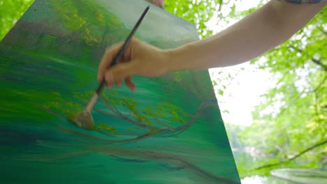 outdoor painter draws on canvas.