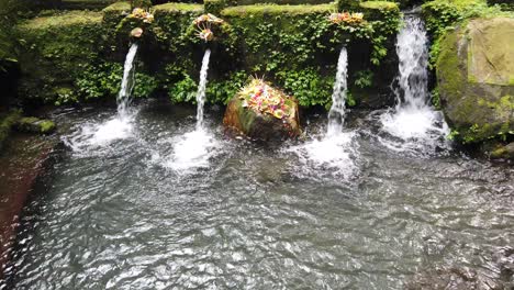 holuy water temple architecture for cleansing ritual in bali indonesia pond and flowers in tampaksiring, pura mengening