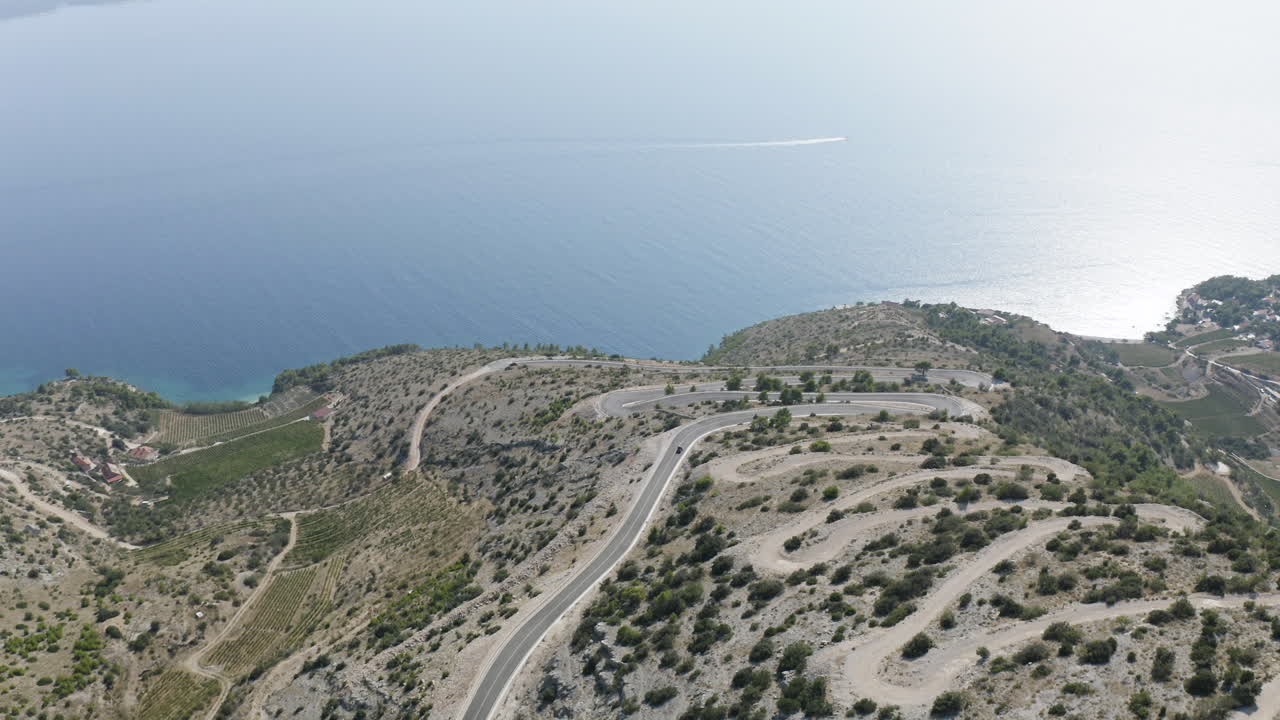 Aerial Shot of Windy Downhill Mountain Road Towards the Coast of Brac Island, Croatia