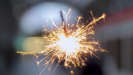 bright sparkler igniting with dazzling lights against a blurred background, close-up