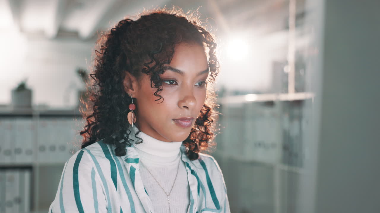 Portrait of a woman with curly hair in an office
