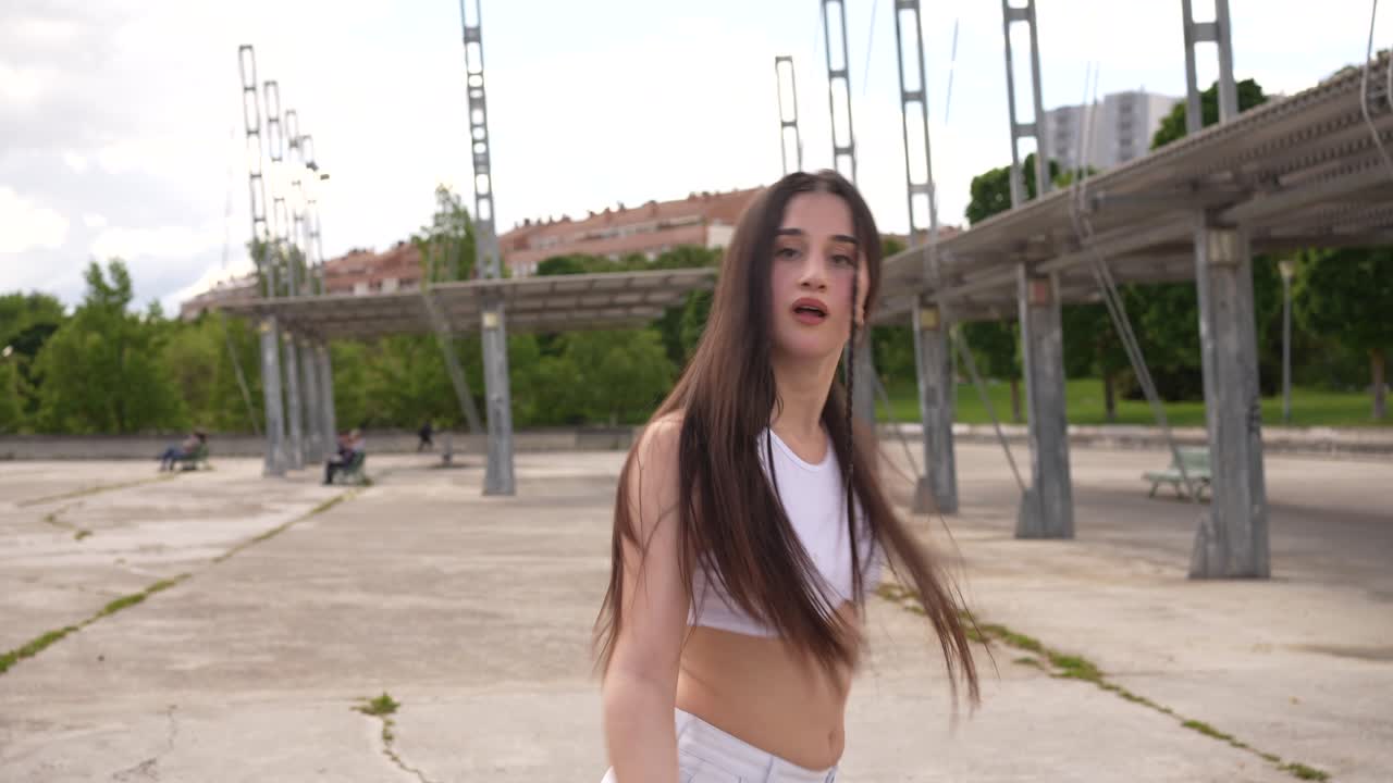 Young woman dancing in an urban park