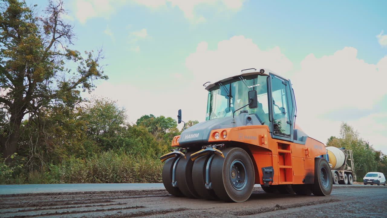 Large road-roller paving a road. Road construction